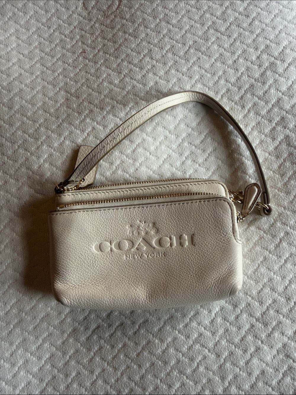 COACH Cream Pebbled Leather Wristlet with Embossed Logo